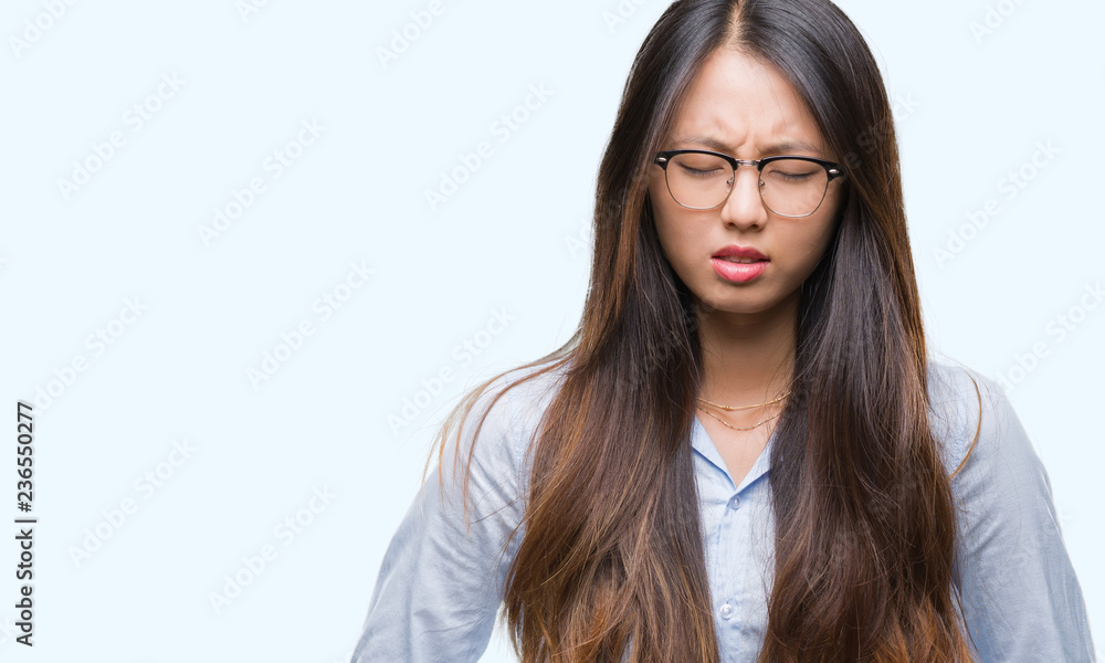 Young asian business woman wearing glasses over isolated background with hand on stomach because indigestion, painful illness feeling unwell. Ache concept. Young asian business woman wearing glasses over isolated background with hand on stomach because indigestion, painful illness feeling unwell. Ache concept.