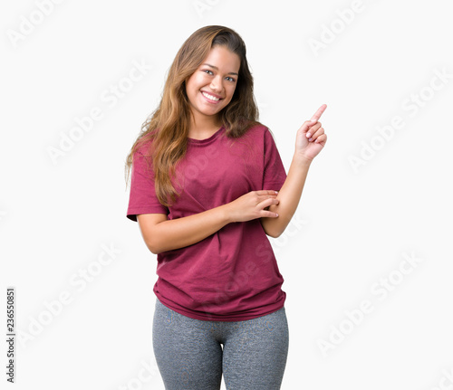 Young beautiful brunette woman over isolated background with a big smile on face, pointing with hand and finger to the side looking at the camera.