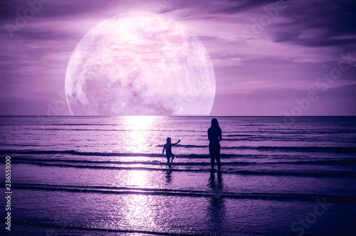 Super moon. Colorful sky with cloud and bright full moon over seascape.