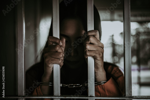 Fotografija Portrait of woman desperate to catch the iron prison,prisoner concept,thailand people,Hope to be free