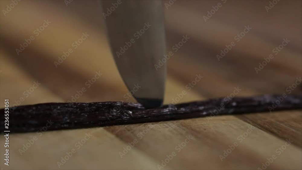 Vanilla Pod is Sliced Open with a Knife, Closeup Vanilla Pod is Sliced Open with a Knife, Closeup