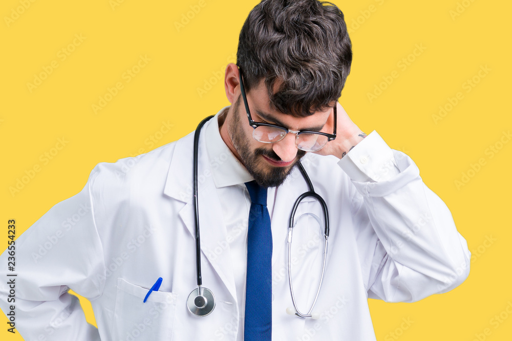 Young doctor man wearing hospital coat over isolated background Suffering of neck ache injury, touching neck with hand, muscular pain Young doctor man wearing hospital coat over isolated background Suffering of neck ache injury, touching neck with hand, muscular pain