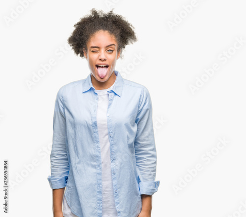 Fotografie Young afro american woman over isolated background sticking tongue out happy with funny expression