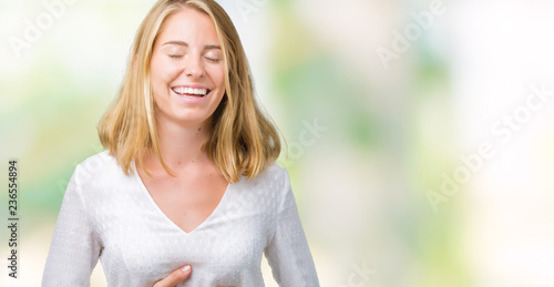 Beautiful young elegant woman over isolated background Smiling and laughing hard out loud because funny crazy joke. Happy expression. © Krakenimages.com