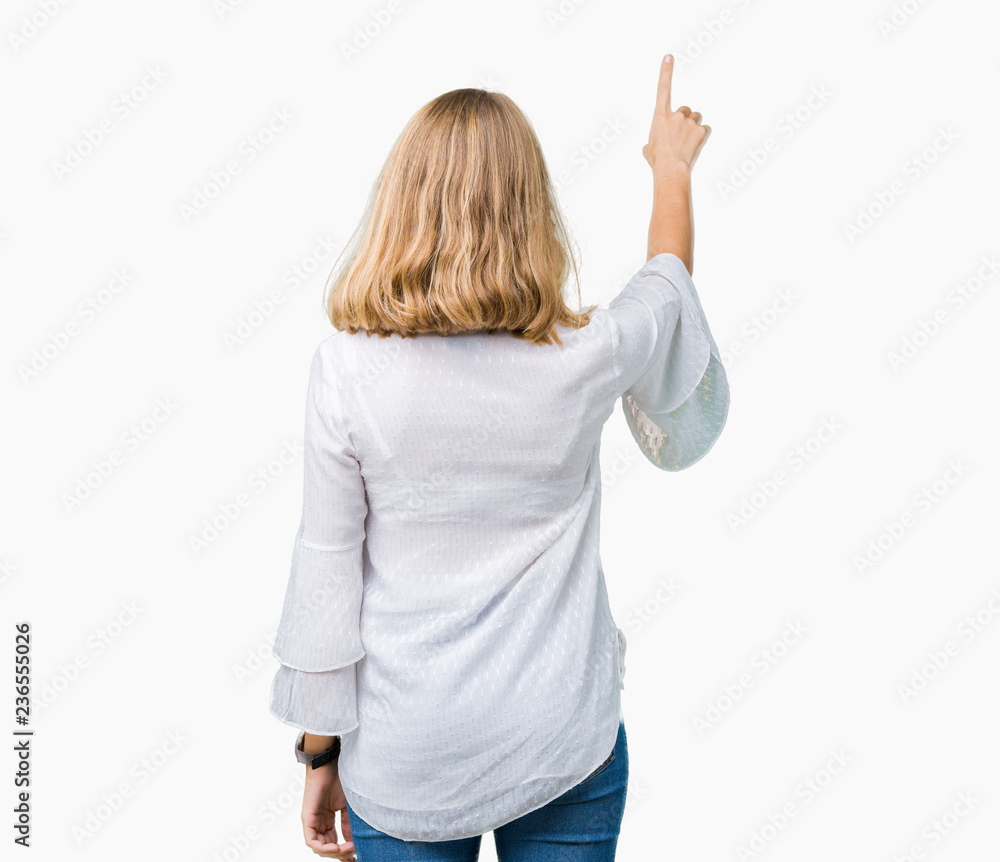 Beautiful young elegant woman over isolated background Posing backwards pointing behind with finger hand Beautiful young elegant woman over isolated background Posing backwards pointing behind with finger hand
