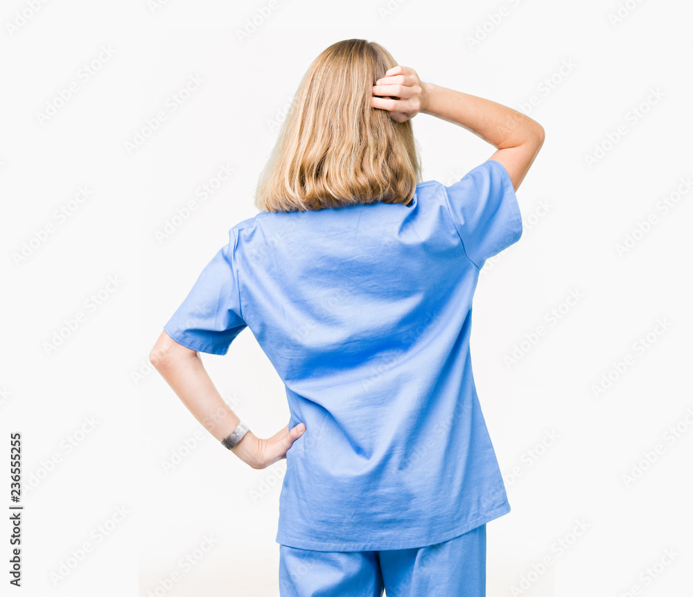 Beautiful young doctor woman wearing medical uniform over isolated background Backwards thinking about doubt with hand on head Beautiful young doctor woman wearing medical uniform over isolated background Backwards thinking about doubt with hand on head