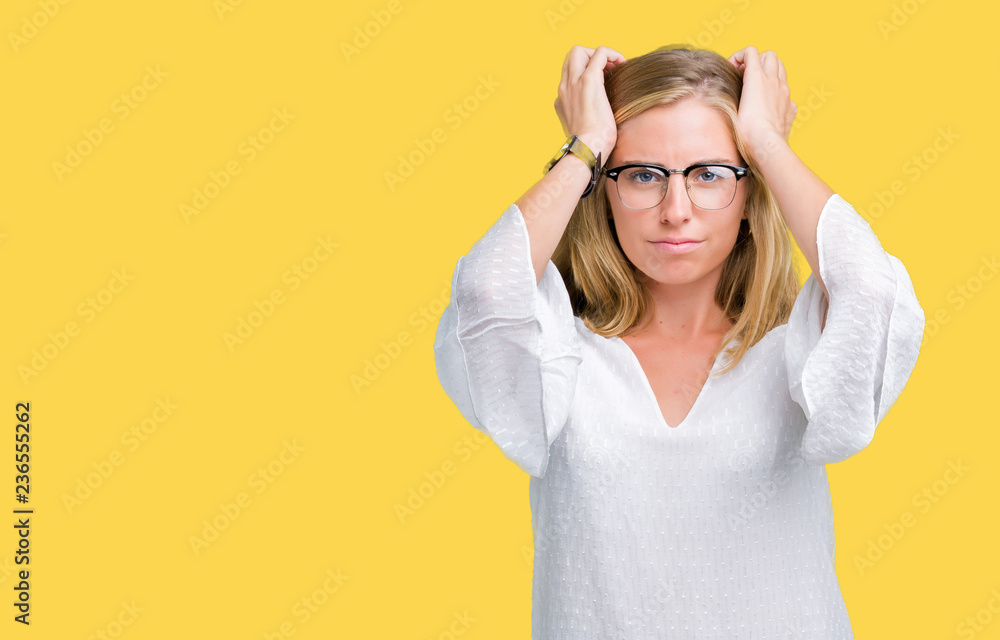Beautiful young woman wearing glasses over isolated background suffering from headache desperate and stressed because pain and migraine. Hands on head. Beautiful young woman wearing glasses over isolated background suffering from headache desperate and stressed because pain and migraine. Hands on head.