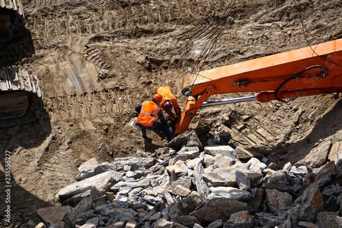 New York City, New York, USA: Workmen examining machinery used for breaking up Manhattan schist bedrock as construction begins on a new building in midtown Manhattan.