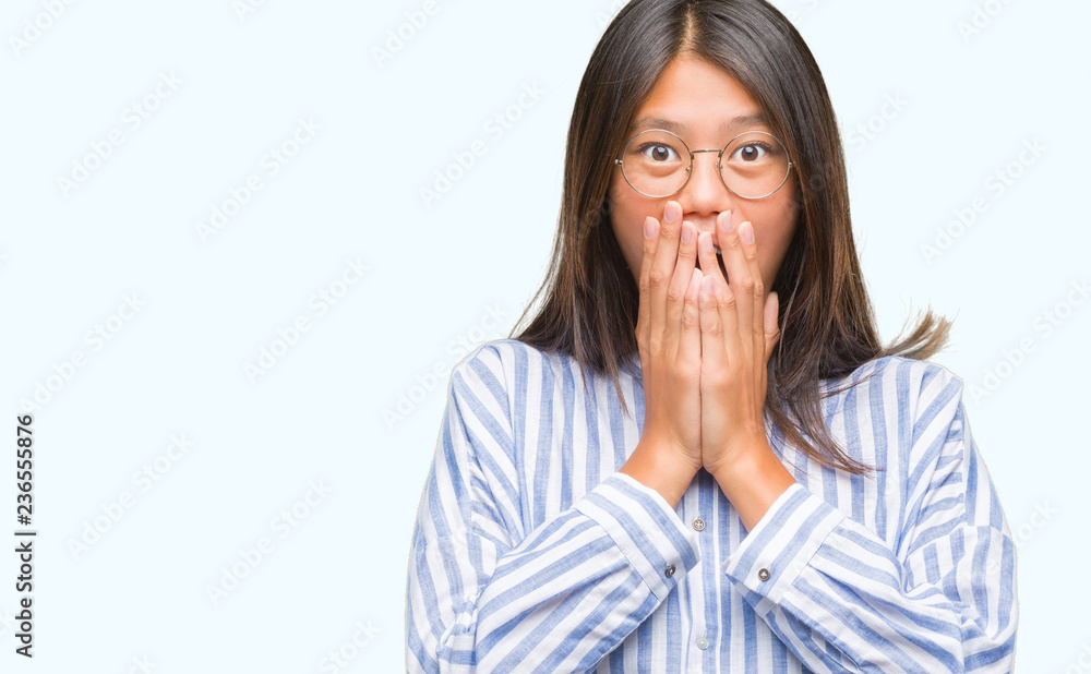 Young asian woman over isolated background shocked covering mouth with hands for mistake. Secret concept. Young asian woman over isolated background shocked covering mouth with hands for mistake. Secret concept.