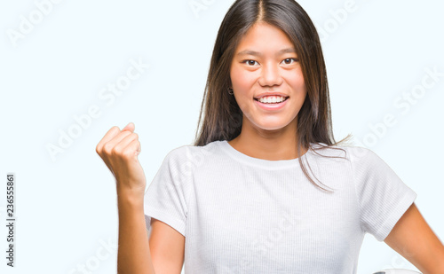 Wallpaper Mural Young asian woman holding football soccer ball over isolated background screaming proud and celebrating victory and success very excited, cheering emotion Torontodigital.ca