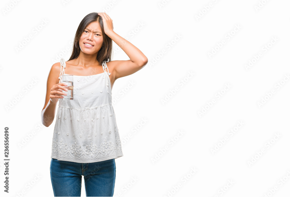 Young asian woman drinking glass of water over isolated background stressed with hand on head, shocked with shame and surprise face, angry and frustrated. Fear and upset for mistake. Young asian woman drinking glass of water over isolated background stressed with hand on head, shocked with shame and surprise face, angry and frustrated. Fear and upset for mistake.