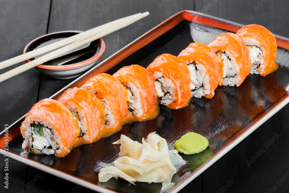Sushi Roll - Sushi made salmon, avocado and cream cheese on dark wooden background. Top view. Japanese cuisine Stock Photo | Adobe Stock