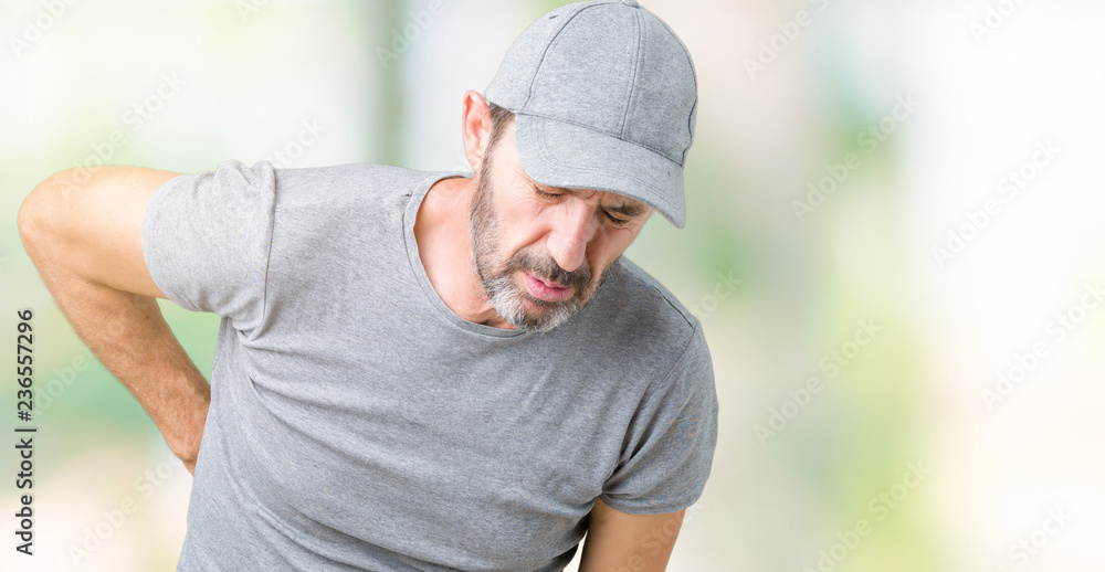 Handsome middle age hoary senior man wearing sport cap over isolated background Suffering of backache, touching back with hand, muscular pain