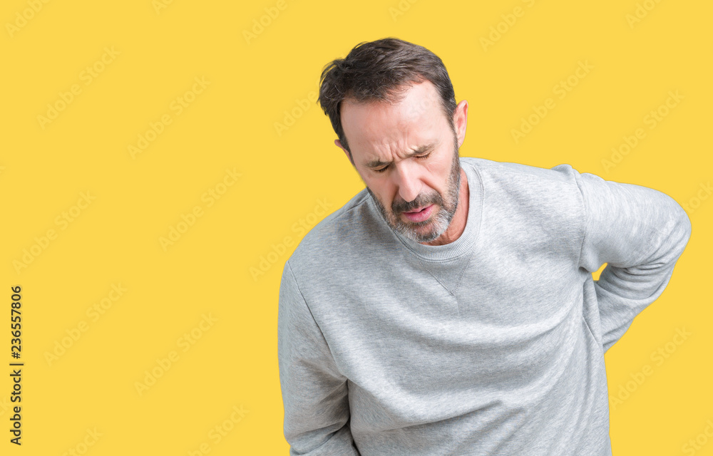 Handsome middle age senior man wearing a sweatshirt over isolated background Suffering of backache, touching back with hand, muscular pain Handsome middle age senior man wearing a sweatshirt over isolated background Suffering of backache, touching back with hand, muscular pain