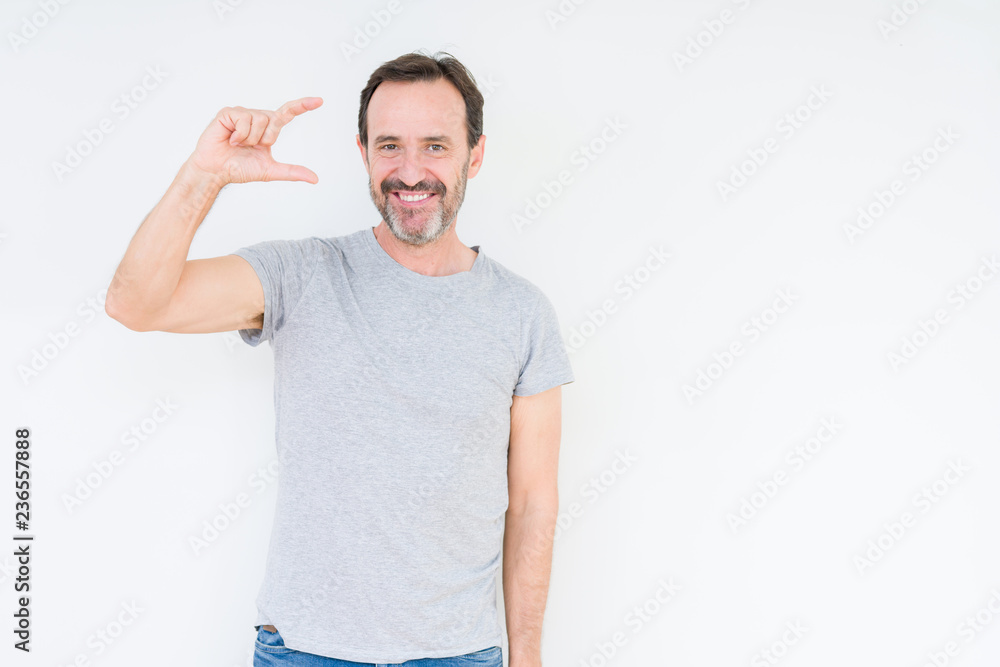 Handsome senior man over isolated background smiling and confident gesturing with hand doing size sign with fingers while looking and the camera. Measure concept. Handsome senior man over isolated background smiling and confident gesturing with hand doing size sign with fingers while looking and the camera. Measure concept.