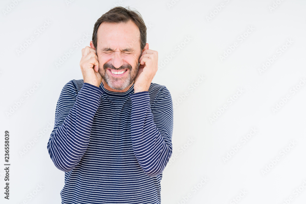 Handsome senior man over isolated background covering ears with fingers with annoyed expression for the noise of loud music. Deaf concept. Handsome senior man over isolated background covering ears with fingers with annoyed expression for the noise of loud music. Deaf concept.