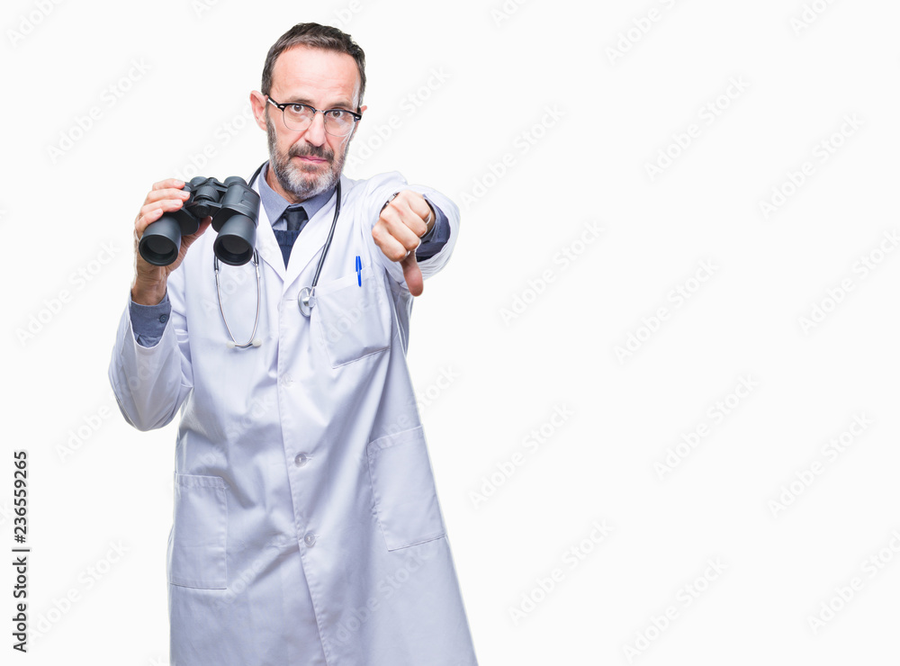 Middle age senior hoary doctor man looking through binoculars isolated background with angry face, negative sign showing dislike with thumbs down, rejection concept Middle age senior hoary doctor man looking through binoculars isolated background with angry face, negative sign showing dislike with thumbs down, rejection concept