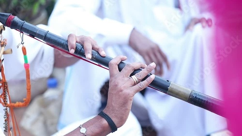 Slow motion video of an artist playing nadaswaram in a wedding in India photo