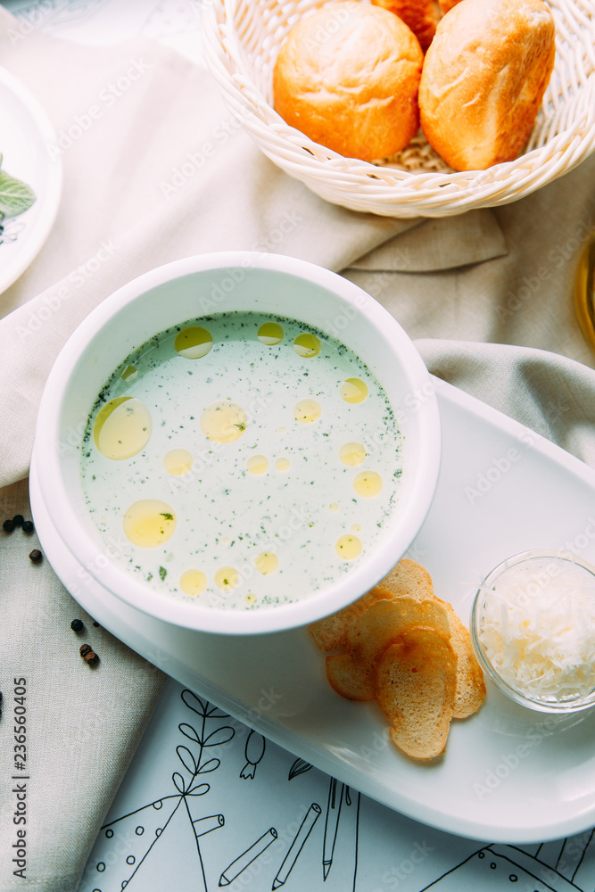 Soup with greens, mushrooms and noodles with chicken. Restaurant dishes with a beautiful serving. Soup with greens, mushrooms and noodles with chicken. Restaurant dishes with a beautiful serving.