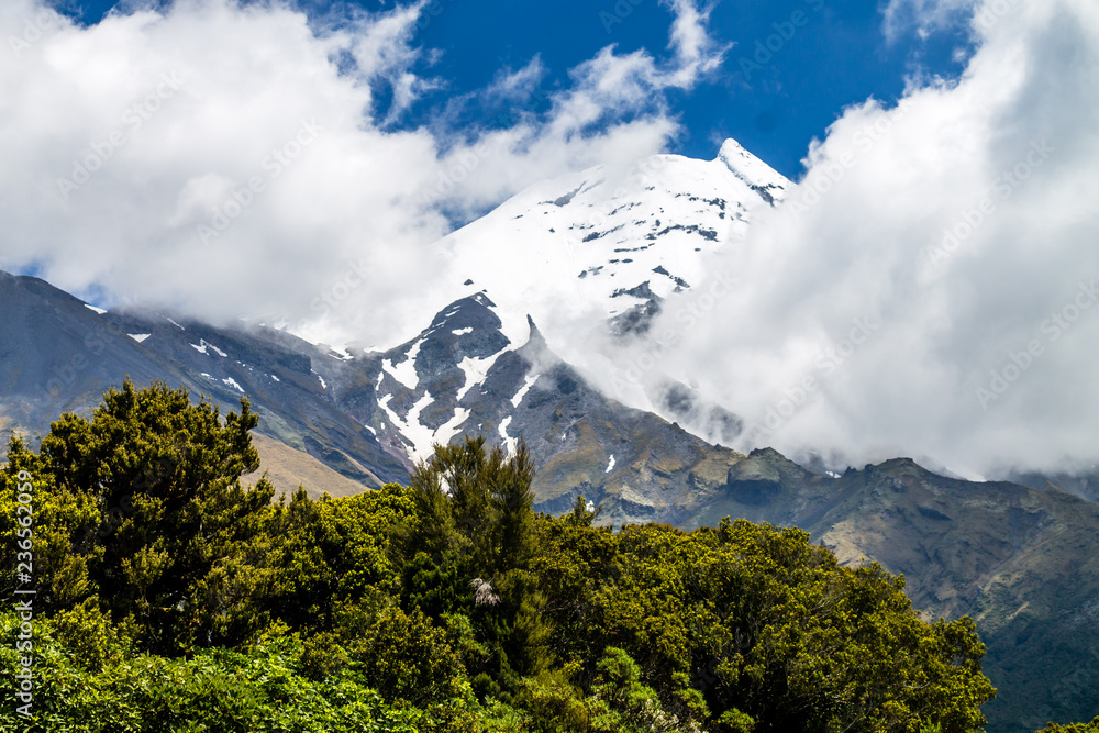 A view of a snow covered Mount Taranaki in the clouds, Edgemont National Park, New Zealand