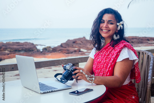 Photography Female India photographer photographing with digital camera on the beach