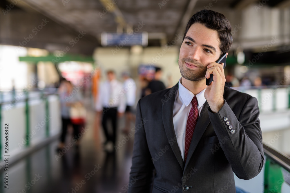 Portrait of businessman in city talking on mobile phone Portrait of businessman in city talking on mobile phone