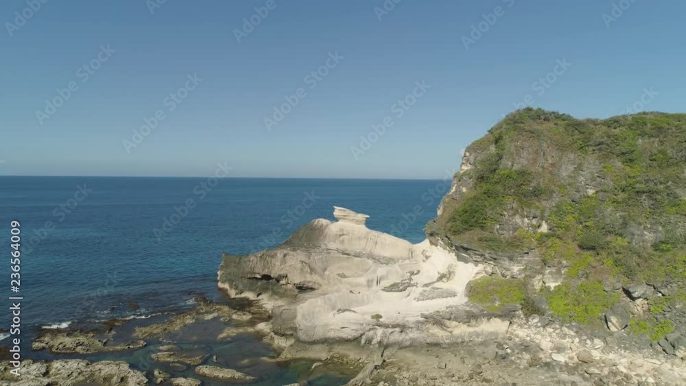 Natural rock formation of limestone stone on the coast. Aerial view of tourist attraction Kapurpurawan Rock Formation in Ilocos Norte Philippines,Luzon. Natural rock formation of limestone stone on the coast. Aerial view of tourist attraction Kapurpurawan Rock Formation in Ilocos Norte Philippines,Luzon.