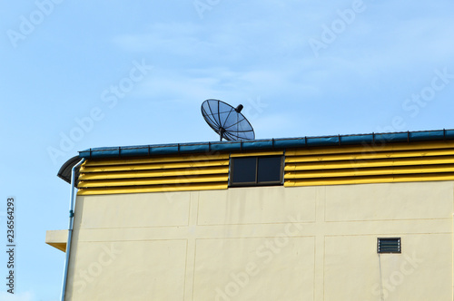 black satellite dish or TV antennas on the house roof photo