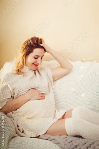 Happy pregnant woman relax on a sofa