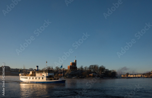 Photography A sunny morning in stockholm harbour, ships and boats in the frosty mist and win