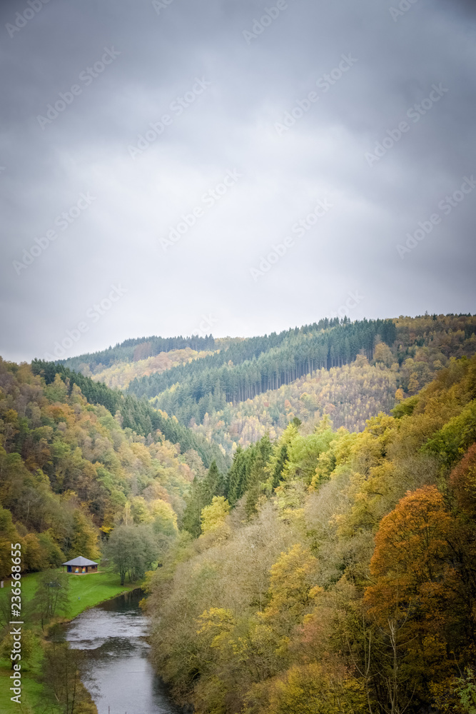 Maboge beach in beautiful autumn scenery and colors with the Ourthe river Ardennes