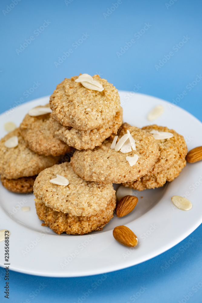 Gluten-Free Cookies almond with almond slice in white plate. Gluten-Free Cookies almond with almond slice in white plate.