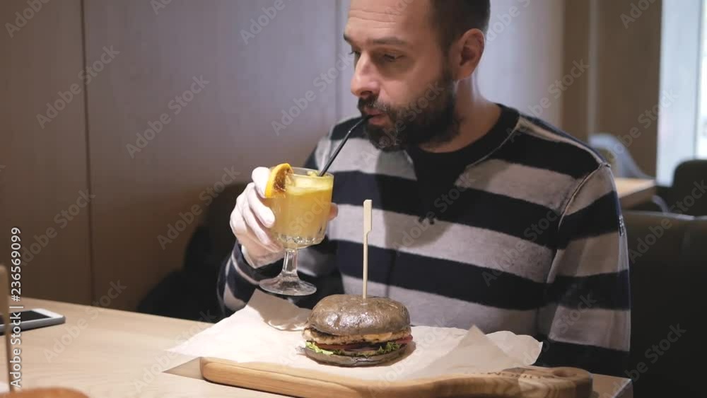 bearded man eating a burger appetizing bearded man eating a burger appetizing
