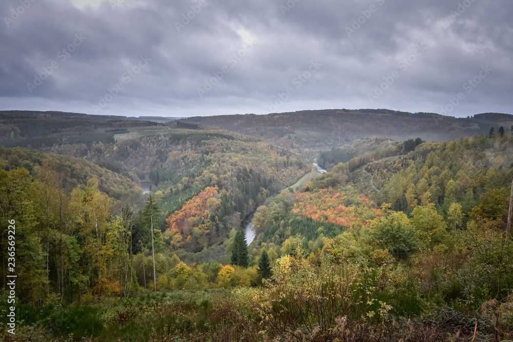 Moody and dark panorama of an Ardennes valley with Ourthe shaping the landscape