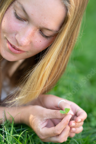 Young woman holding a shamrock