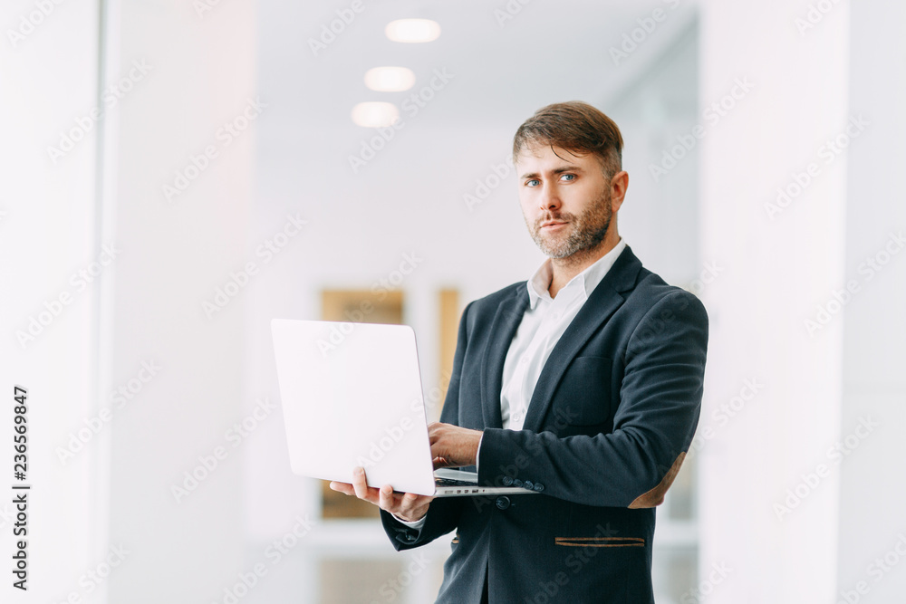 An employee at the laptop, the business aspects. Bright and stylish office interior and cut out the background. An employee at the laptop, the business aspects. Bright and stylish office interior and cut out the background.