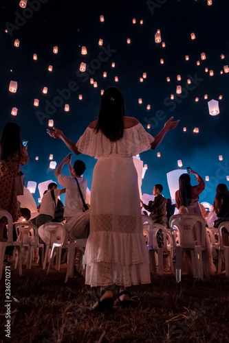 Photography young woman release white lantern in the sky, Chiang Mai Thailand white lantern