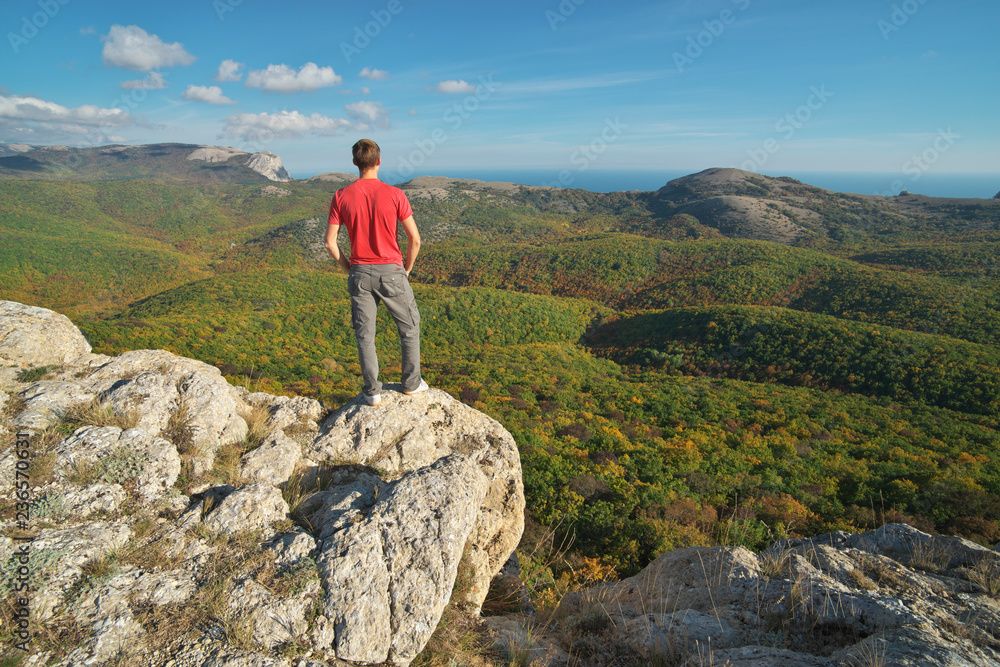 Man standing on the edge of cliff mountain. Man standing on the edge of cliff mountain.