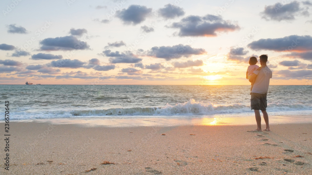 Father and daughter on sea beach