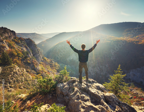Man standing on the cliff in mountain.