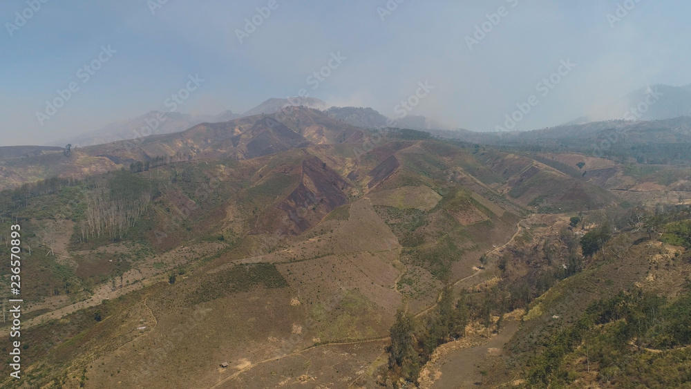 Mountain hilly landscape in rural areas with agricultural land in Java Indonesia. aerial view slopes mountains covered with vegetation. mountain landscape