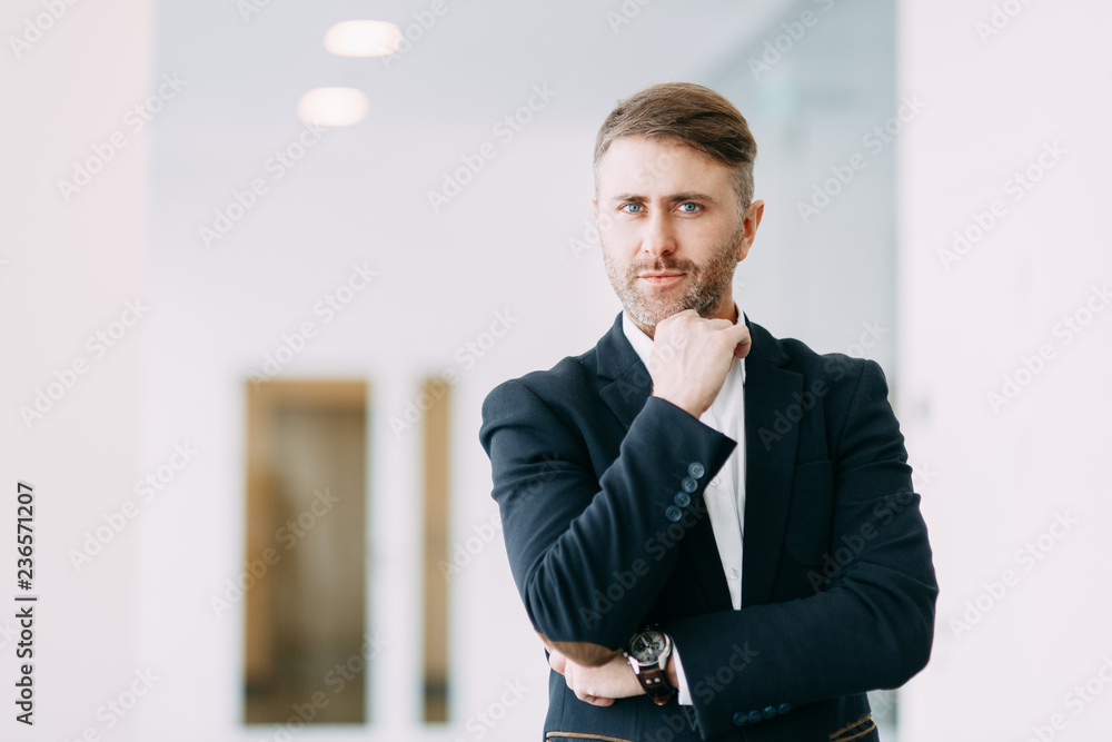 Confident emotional man at work. Bright interior with a businessman. Confident emotional man at work. Bright interior with a businessman.