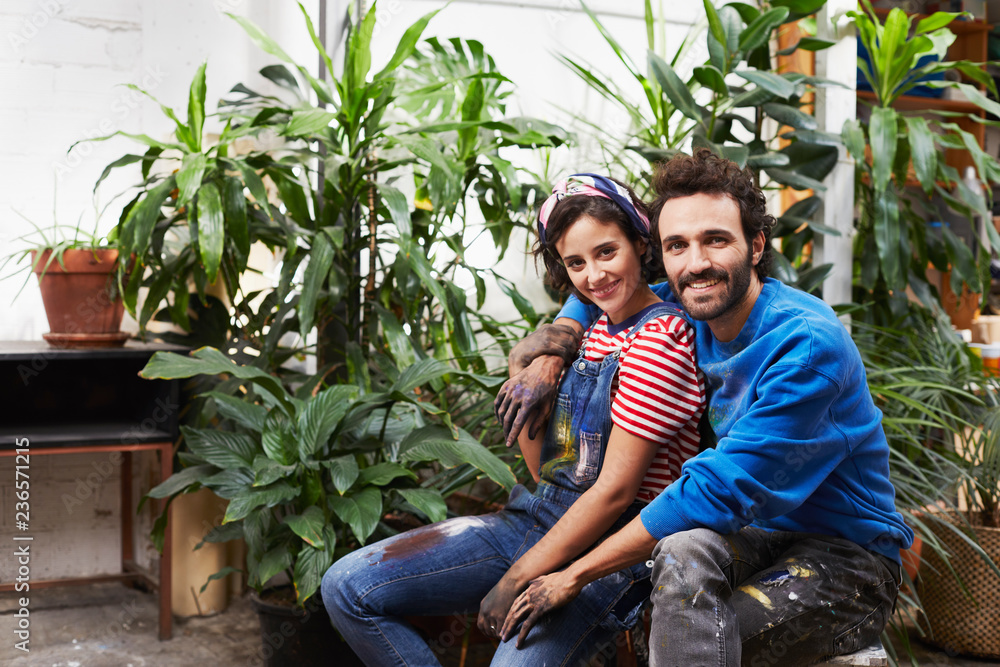 Loving Male And Female Artists By Plants In Studio Loving Male And Female Artists By Plants In Studio