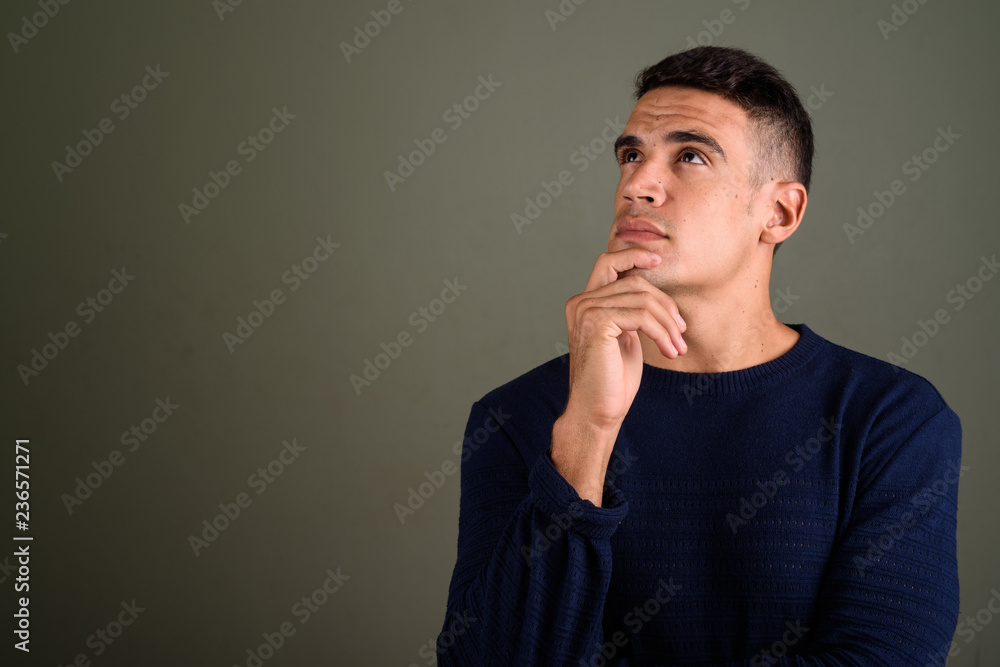Young handsome man thinking and looking up Young handsome man thinking and looking up