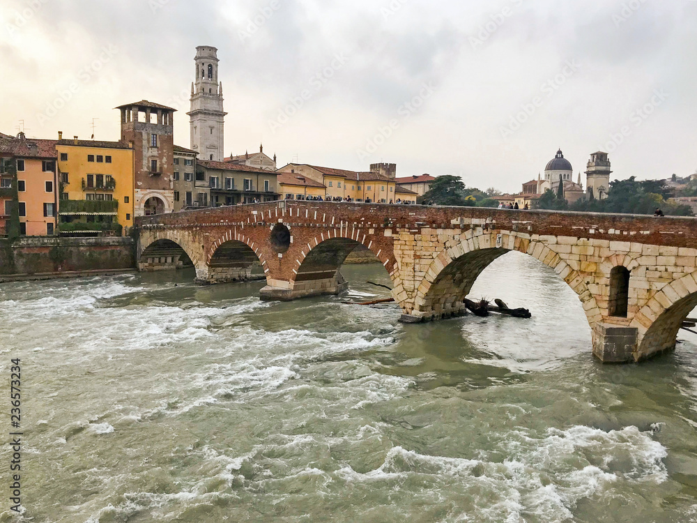View of the old historical stone bridge Ponte Pietra and Adige river in center of the city Verona. Italy View of the old historical stone bridge Ponte Pietra and Adige river in center of the city Verona. Italy