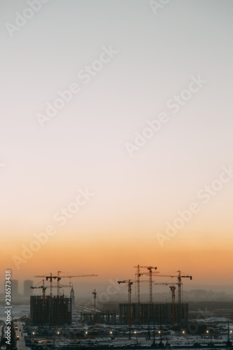 Construction of the building at dawn. Background the city of industry.