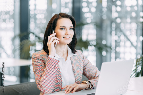 Girl blogger calls on the phone and agrees. Emotional portraits at work. Free Download Girl blogger calls on the phone and agrees. Emotional portraits at work. - GFXLoad