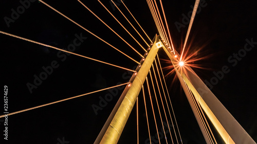 illuminated central pylon of cable suspension bridge photo