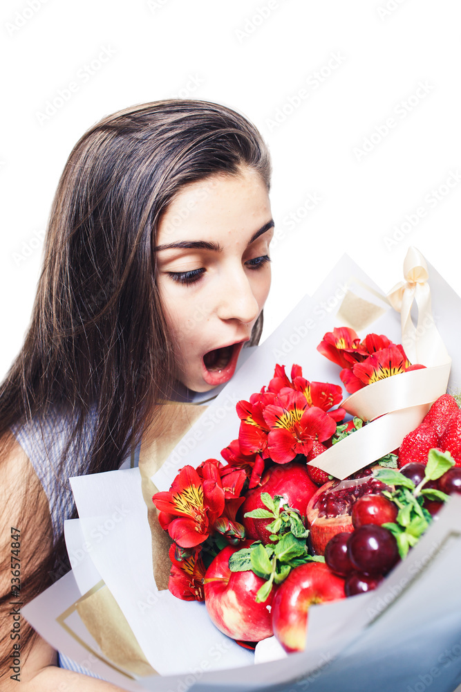 shocked young girl with large fruit bouquet in her hands shocked young girl with large fruit bouquet in her hands