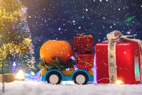 Toy car carries gifts in the new year. The concept of the Christmas mood © Artem